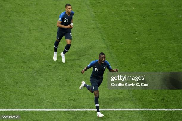 Kylian Mbappe and Blaise Matuidi of France celebrate after Mario Mandzukic of Croatia scores an own goal for France's first goal during the 2018 FIFA...
