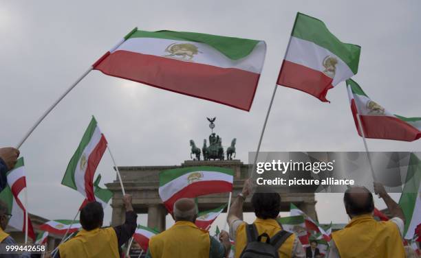 Demonstrators waves Iranian flags which were official until the Islamic Revolution in 1979, in front of Brandenburg Gate in Berlin, Germany, 26...