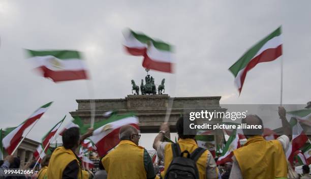 Demonstrators waves Iranian flags which were official until the Islamic Revolution in 1979, in front of Brandenburg Gate in Berlin, Germany, 26...