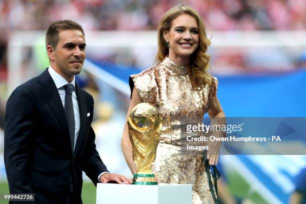 Former Germany captain Philipp Lahm and Natalia Vodianova pose with the world cup trophy prior to the FIFA World Cup Final at the Luzhniki Stadium,...