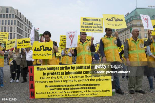 Demonstrators pose with banners and signs in front of Brandenburg Gate in Berlin, Germany, 26 August 2017. The National Resistance Council in Germany...