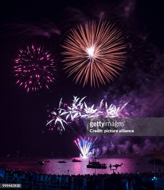 Visitors watch the traditional fireworks of the festival weekend 'Steinhuder Meer in Flammen' at the Steinhude Lake in Steinhude, Germany, 26 August...