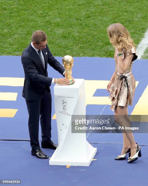 Former Germany captain Philipp Lahm and Natalia Vodianova place the world cup trophy on a plinth prior to the FIFA World Cup Final at the Luzhniki...