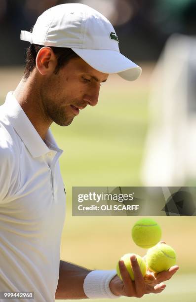 Serbia's Novak Djokovic prepares to serve to South Africa's Kevin Anderson in their men's singles final match on the thirteenth day of the 2018...