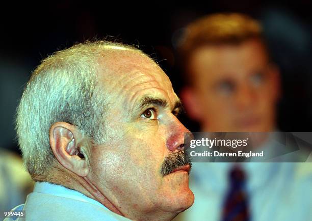 Leigh Matthews of the Brisbane Lions watchers the votes being counted as Michael Voss looks on during the AFL Brownlow Medal presentation at the...