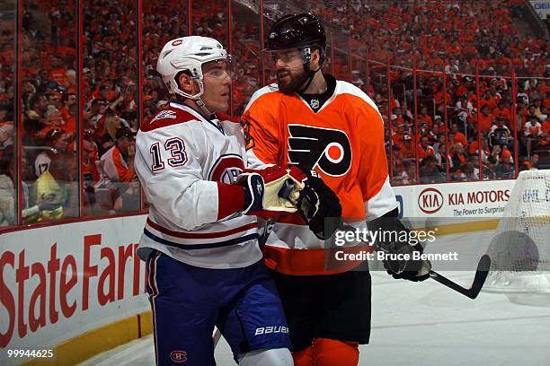 Mike Cammalleri of the Montreal Canadiens gets checked by Ville Leino of the Philadelphia Flyers in Game 1 of the Eastern Conference Finals during...