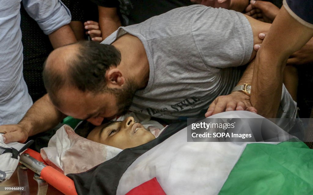 (EDITORS NOTE: Image depicts death.) A father seen kissing...