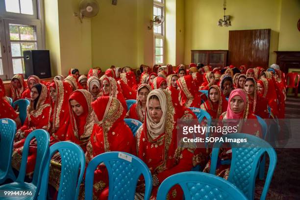 Kashmiri Muslim brides sit for a mass marriage event in Srinagar, Indian controlled Kashmir on Sunday. Mass wedding of 105 Muslim couples held in...