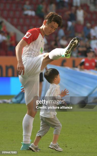Augsburg's Ja-Cheol Koo playing with his son after the Bundesliga match pitting FC Augsburg vs Borussia Monchengladbach in the WWK Arena in Augsburg,...