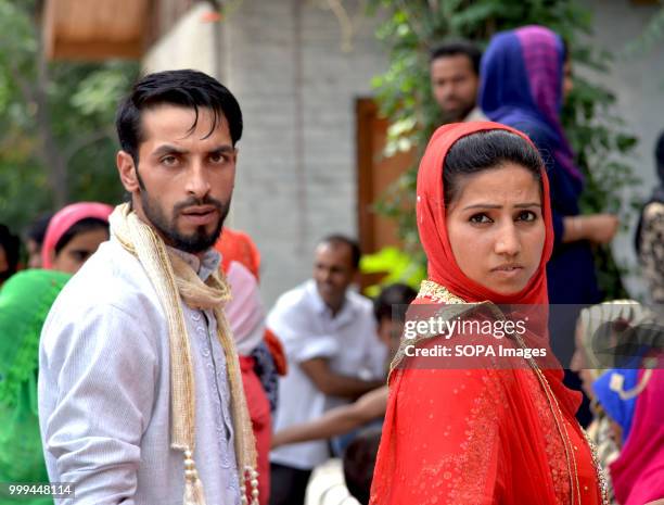 Kashmiri Muslim bride and groom attend a mass-wedding ceremony in Sonwar area of Srinagar, the summer capital of Indian controlled Kashmir, India. At...