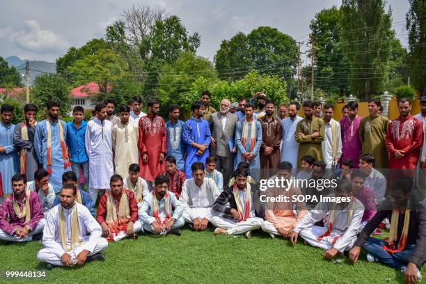 Kashmiri Muslim grooms sit for a group photo during mass marriage event in Srinagar, Indian controlled Kashmir on Sunday. Mass wedding of 105 Muslim...