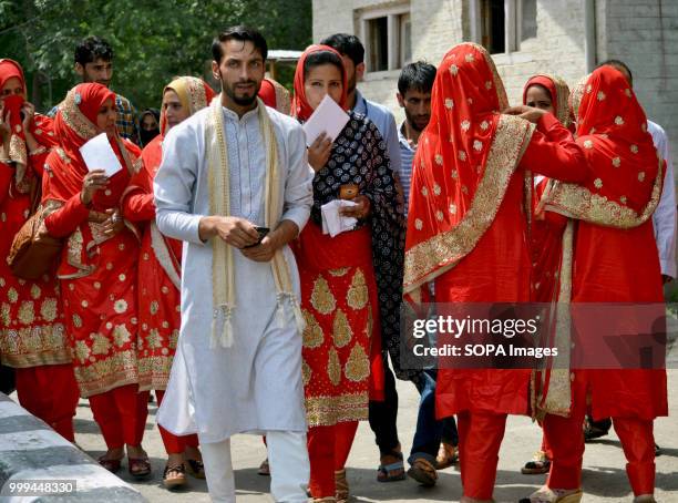 Kashmiri Muslim bride and groom attend a mass-wedding ceremony in Sonwar area of Srinagar, the summer capital of Indian controlled Kashmir, India. At...