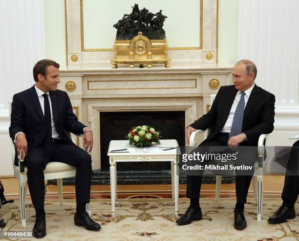 Russian President Vladimir Putin and French President Emmanuel Macron smile during their talks at the Kremlin, in Moscow, Russia, July 15, 2018....