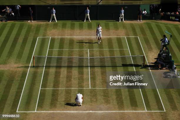 Novak Djokovic of Serbia and Kevin Anderson of South Africa react to Championship point during the Men's Singles final on day thirteen of the...