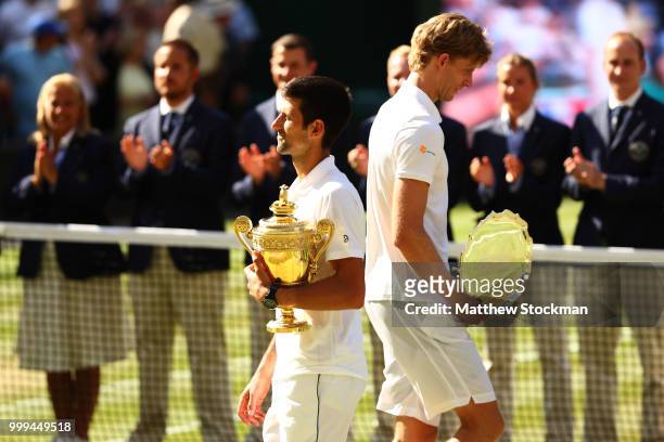 Novak Djokovic of Serbia and Kevin Anderson of South Africa hold their trophies after the Men's Singles final on day thirteen of the Wimbledon Lawn...