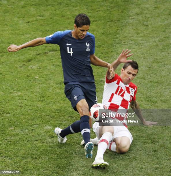 Raphael Varane of France and Mario Mandzukic of Croatia vie for the ball during the first half of the World Cup final between the two counties at...