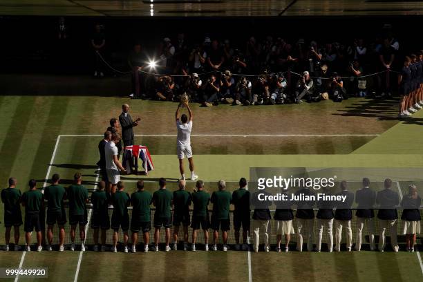 Novak Djokovic of Serbia lifts the trophy after winning the Men's Singles final against Kevin Anderson of South Africa on day thirteen of the...