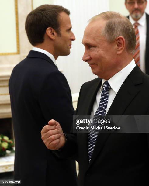 Russian President Vladimir Putin greets French President Emmanuel Macron during their talks at the Kremlin, in Moscow, Russia, July 15, 2018. Macron...