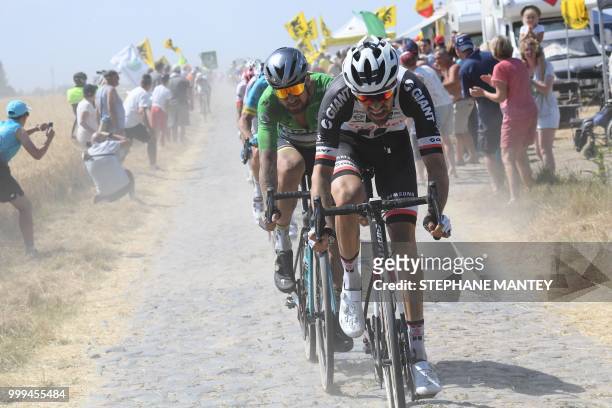 Slovakia's Peter Sagan , wearing the best sprinter's green jersey and Netherlands' Tom Dumoulin ride through a cobblestone section during the ninth...
