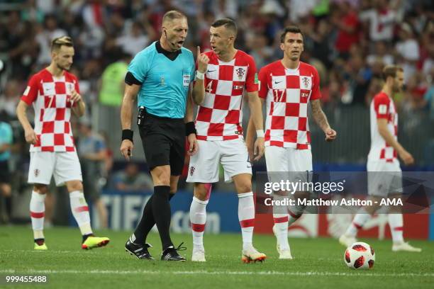 Ivan Perisic of Croatia in discussion with match referee Nestor Pitana after conceeding a penalty for a handball which was decided through a VAR...