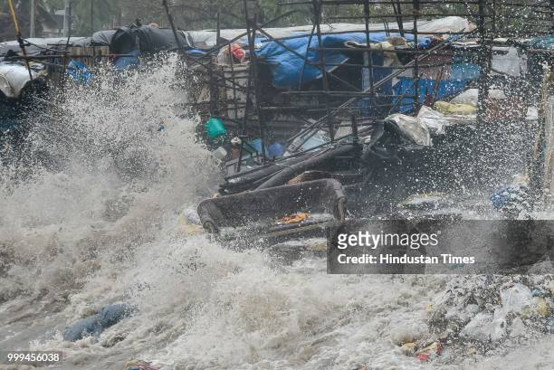 High tide waves at Versova beach, on July 14, 2018 in Mumbai, India. Mumbaikars had to face another tough battle, as the high tide hit the city at...