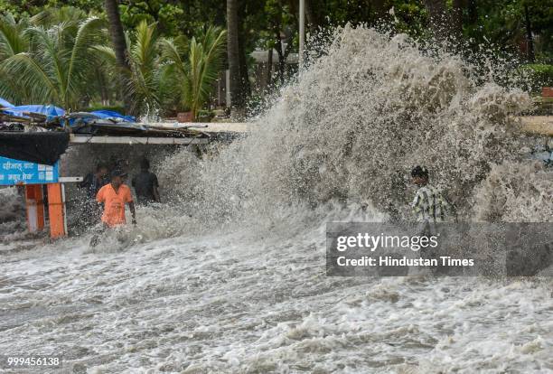People enjoy high tide at Dadar, on July 14, 2018 in Mumbai, India. Mumbaikars had to face another tough battle, as the high tide hit the city at...