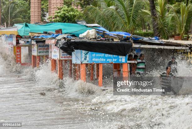 People search valuable things during high tide at Dadar, on July 14, 2018 in Mumbai, India. Mumbaikars had to face another tough battle, as the high...