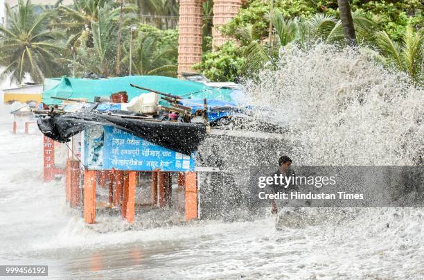 People search valuable things during high tide at Dadar, on July 14, 2018 in Mumbai, India. Mumbaikars had to face another tough battle, as the high...