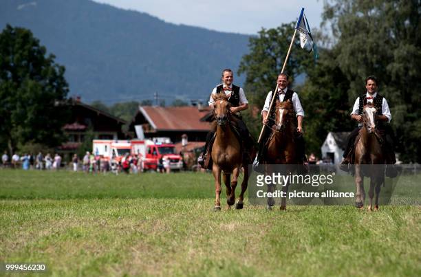 Participants of the traditional 'Rosstag' pass by meadows and mountains at the Tegernsee lake in Rottach-Egern, Germany, 27 August 2017. Dozens of...