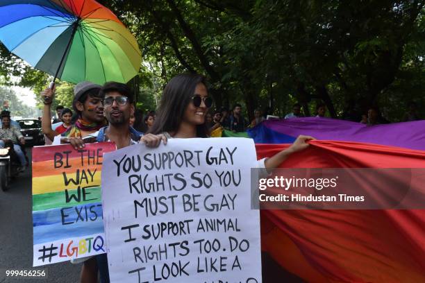 Lesbian, gay, bisexual, transgender and queer community members and supporters take part in a pride parade at Link road, on July 15, 2018 in Bhopal,...