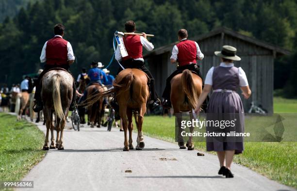 Participants of the traditional 'Rosstag' pass by meadows and mountains at the Tegernsee lake in Rottach-Egern, Germany, 27 August 2017. Dozens of...