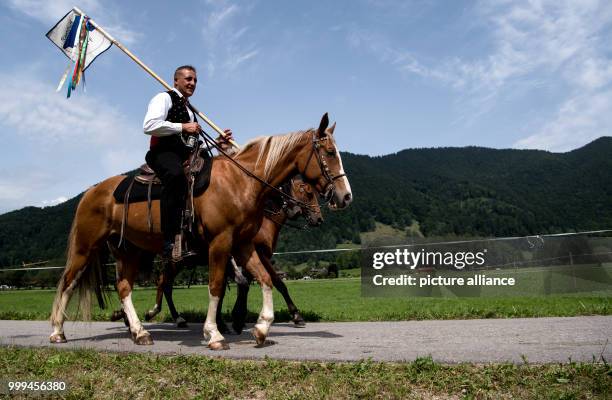 Participants of the traditional 'Rosstag' pass by meadows and mountains at the Tegernsee lake in Rottach-Egern, Germany, 27 August 2017. Dozens of...