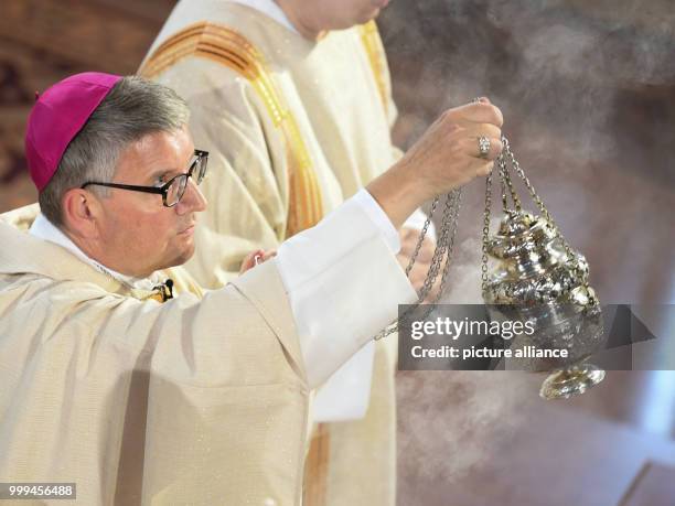 Peter Kohlgraf, new bishop of Mainz, swings the thurible during his ordination in the Cathedral in Mainz, Germany, 27 August 2017. The 50-year-old...