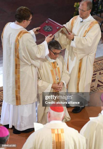 The Holy Gospel is being held above the head of Peter Kohlgraf during his episcopal ordination in the Cathedral in Mainz, Germany, 27 August 2017....