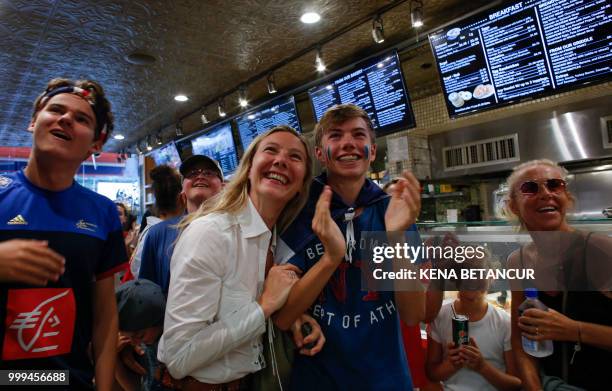 French fans react as France scores a goal, as they watch the World Cup final match between France vs Croatia on July 15, 2018 in New York. - The...