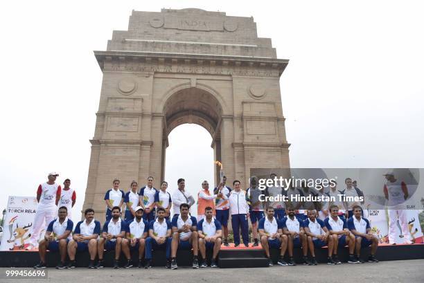 Officials and athletes pose for a group photo in front of the India Gate during the 'Torch Relay' begins for the 18th Asian Games Jakarta Palembang...