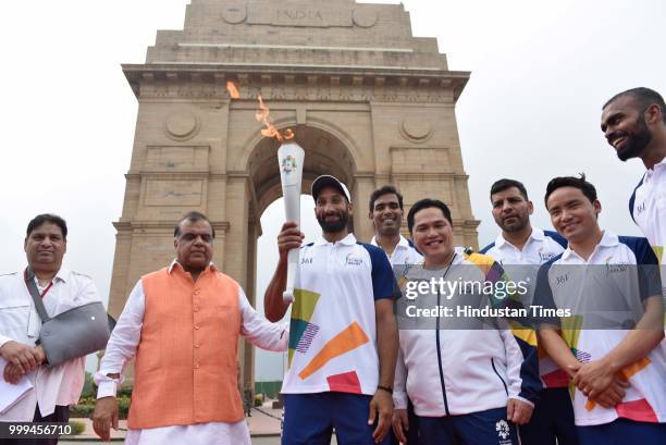 Hockey player Sardar Singh holds the torch during the 'Torch Relay' begins for the 18th Asian Games Jakarta Palembang 2018, after the flame -...