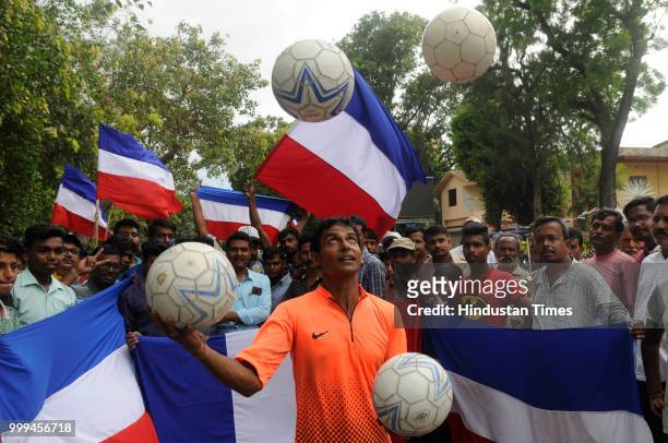 Residents of Chandannagar, a former French colony till 1950, cheer for France before FIFA World Cup Final against Croatia at Strand beside river...