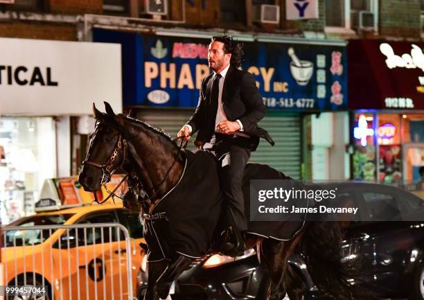 Keanu Reeves seen riding a horse on location for 'John Wick 3' in Brooklyn on July 14, 2018 in New York City.