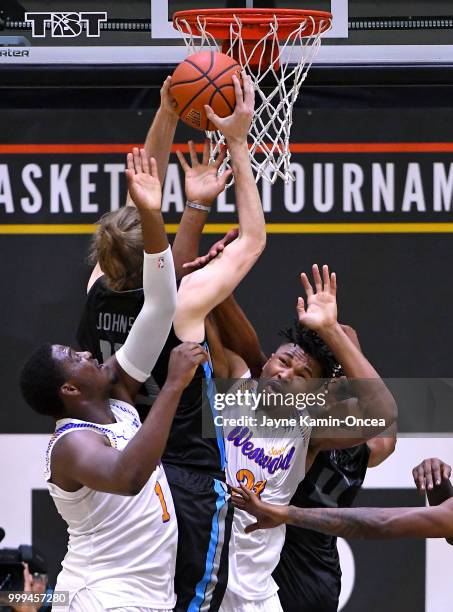 Tyrone Nash and Jordan Adams of the Sons of Westwood defend Lucas Johnson of the D3 as he drives to the basket during the Western Regional of The...