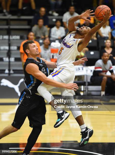 Khalif Wyatt of the Sons of Westwood is fouled by Ben Strong of the D3 as he drives to the basket during the Western Regional game of The Basketball...