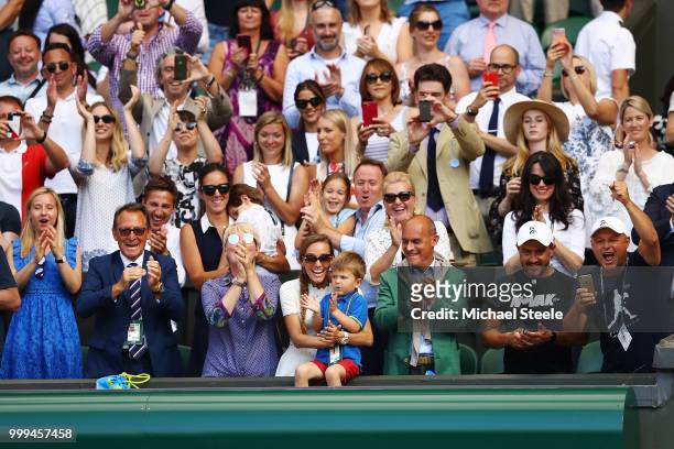 Jelena Djokovic , wife of Novak Djokovic of Serbia, and their son Stefan Djokovic applaud after the Men's Singles final on day thirteen of the...