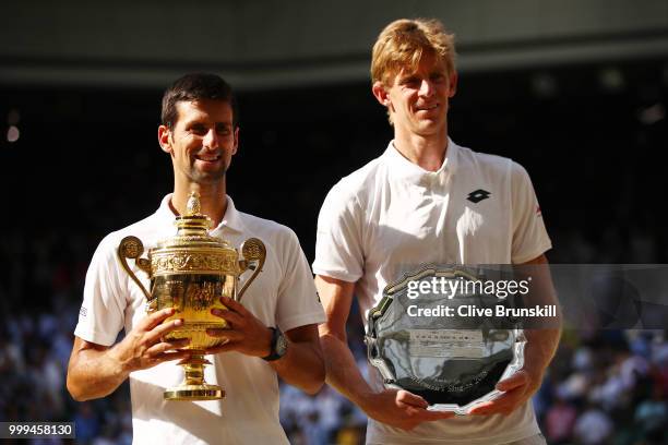 Novak Djokovic of Serbia and Kevin Anderson of South Africa pose together with their trophies after the Men's Singles final on day thirteen of the...