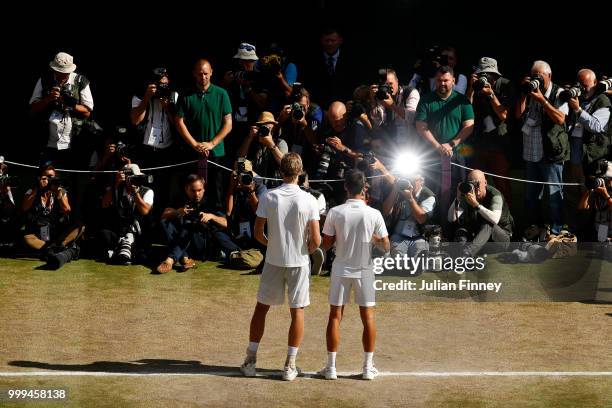Novak Djokovic of Serbia and Kevin Anderson of South Africa pose together with their trophies after the Men's Singles final on day thirteen of the...