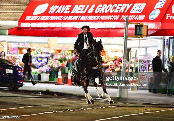 Keanu Reeves' stunt double seen riding a horse on location for 'John Wick 3' in Brooklyn on July 14, 2018 in New York City.