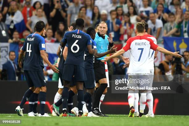 Players from France appeal to referee after Ivan Perisic of Croatia handles the ball inside the penalty area, leading to a VAR review, and then a...