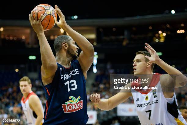 France's Boris Diaw attempting to get the ball past Germany's Johannes Voigtmann during the Germany vs France match at the Mercedes-Benz Arena in...