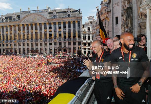 Belgium's head coach Roberto Martinez and Belgium's assistant coach Thierry Henry celebrate at the Grand Place/Grote Markt in Brussels city center,...