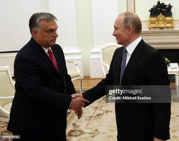 Russian President Vladimir Putin shakes hands with Hungarian Prime Minister Viktor Orban during their meeting at the Kremlin, in Moscow, Russia, July...