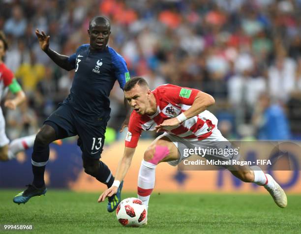 Ngolo Kante of France puts pressure on Ivan Perisic of Croatia during the 2018 FIFA World Cup Final between France and Croatia at Luzhniki Stadium on...